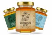 Honey jar labels on glass jars of wildflower, forest, and acacia honey with natural illustrated designs.